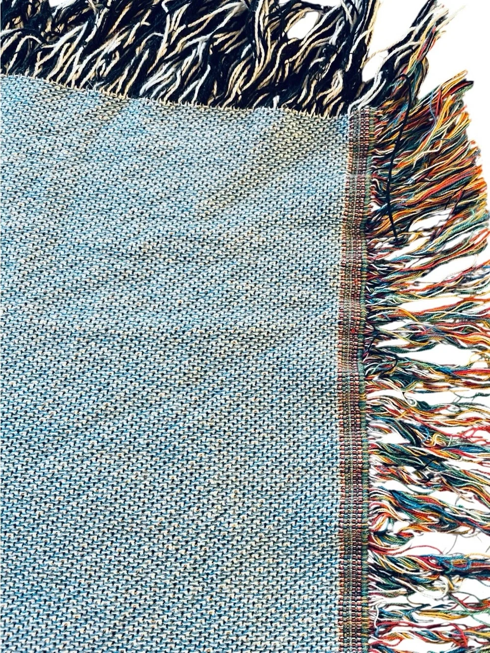 Outcasty cotton throw, relaxing sloth with book, shown on a Queen size bed